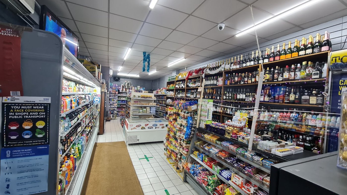 The main aisle at Barry's Food & Wine with chilled drinks, groceries and confectionery