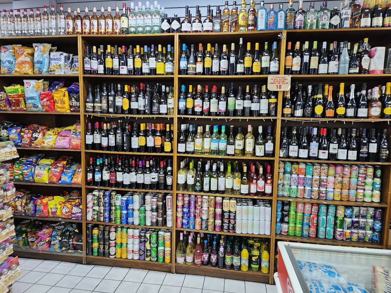 Floor-to-ceiling wine and spirits shelves inside Barry's Food & Wine, Hoxton Street