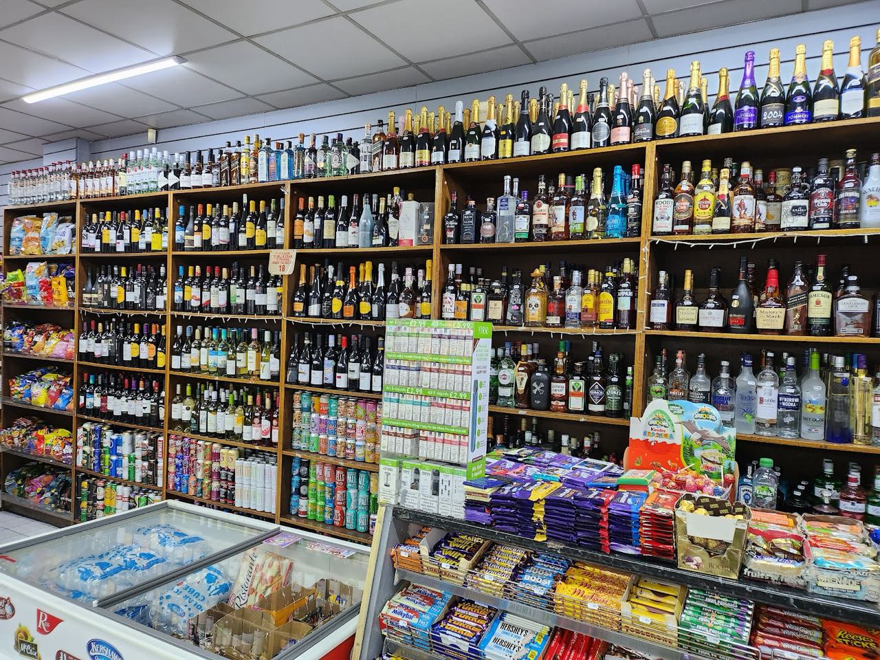 Wine, champagne and spirits stacked to the ceiling alongside snacks at Barry's Food & Wine